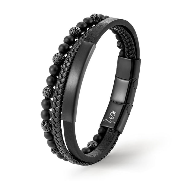 Schwarzes Lederarmband mit Lavasteinen, elegant präsentiert in einer Uniqal-Geschenkbox.