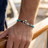 Maritimes Herren Ankerarmband mit Gravur, blauem Segeltau und Edelstahl Anker am Meer getragen