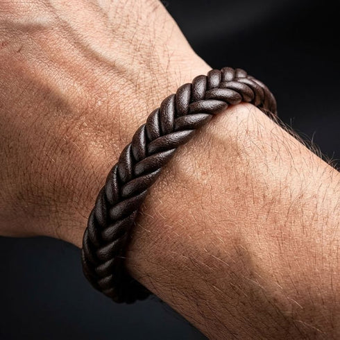 BROWN BRAID Zopfarmband am Handgelenk eines Mannes, mit brauner Flechtstruktur in Nahaufnahme vor dunklem Hintergrund