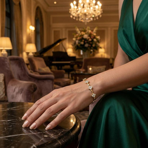 Vergoldetes Damenarmband mit strahlenden Moissanit Blüten getragen zu eleganter Abendmode in luxuriösem Ambiente.