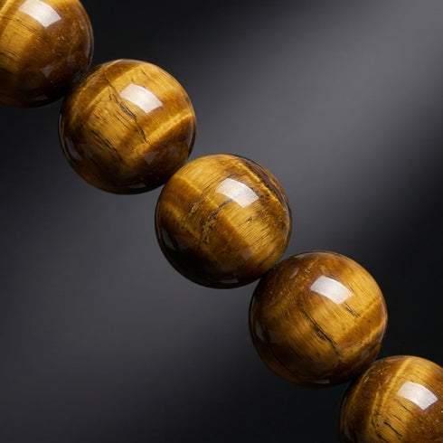 Uniqal Tigerauge Naturperlen als Materialansicht – gleichmäßige Form und charakteristischer Glanz