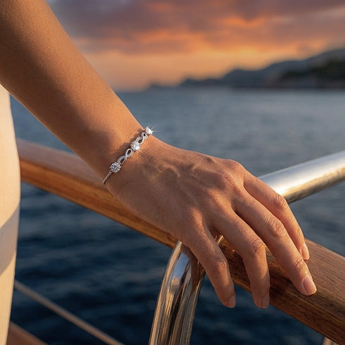 Elegantes Infinity Damenarmband mit funkelnden Moissanit Steinen auf einem Boot getragen, personalisierbarer Schmuck aus Sterling Silber