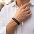 Uniqal PASSION RED TIGER EYE Armband für Männer – stilvolles Herrenaccessoire mit roten Tigerauge-Perlen, schwarzen Kugeln und geflochtenem Leder