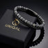 Uniqal PASSION SPECTROLITE Herrenarmband – schwarzes Flechtleder mit grau gemusterten Spectrolite-Perlen und elegantem schwarzem Verschluss